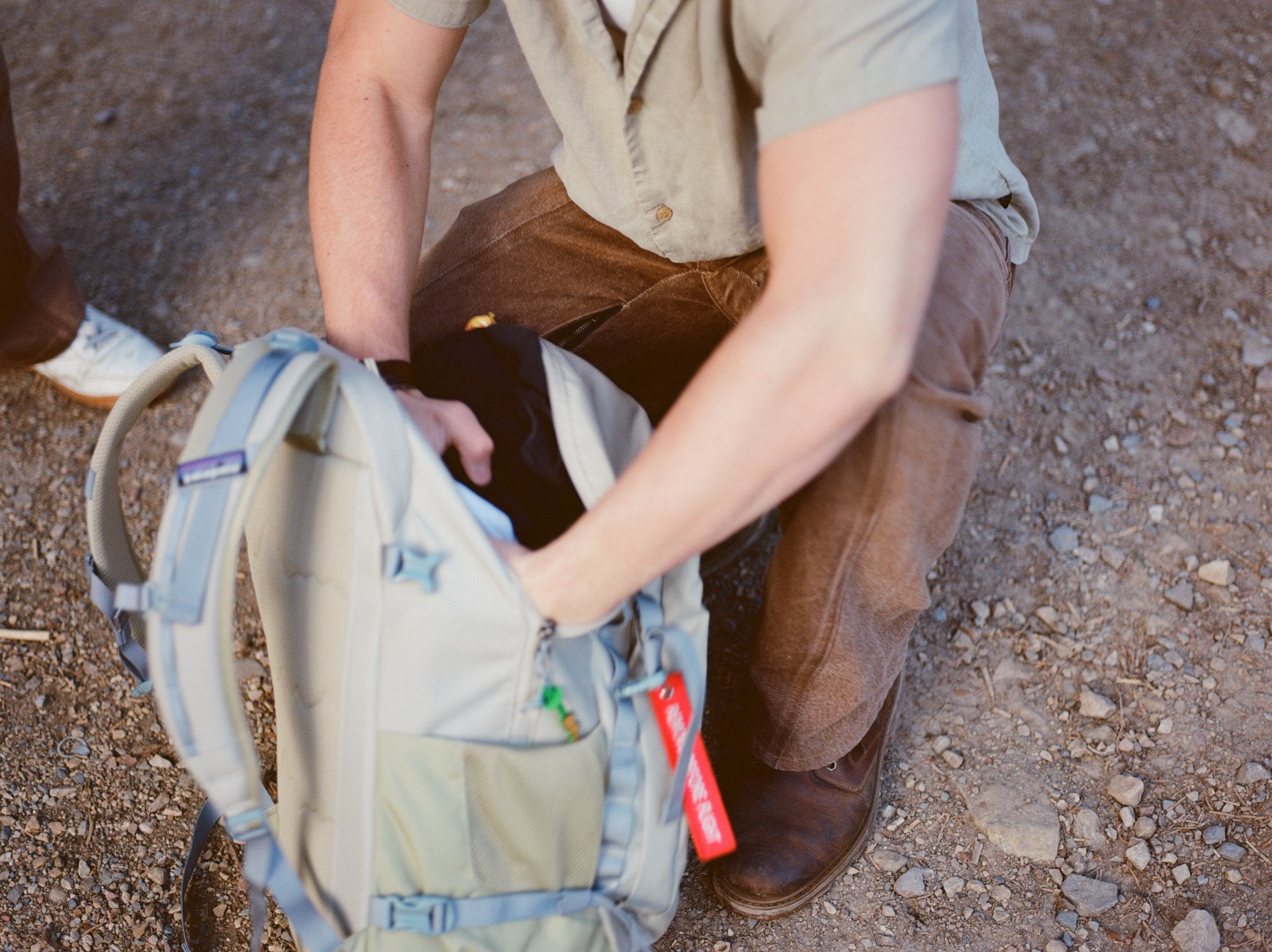 Wearing the Functional Jeans outdoors, packing a bag on a trail